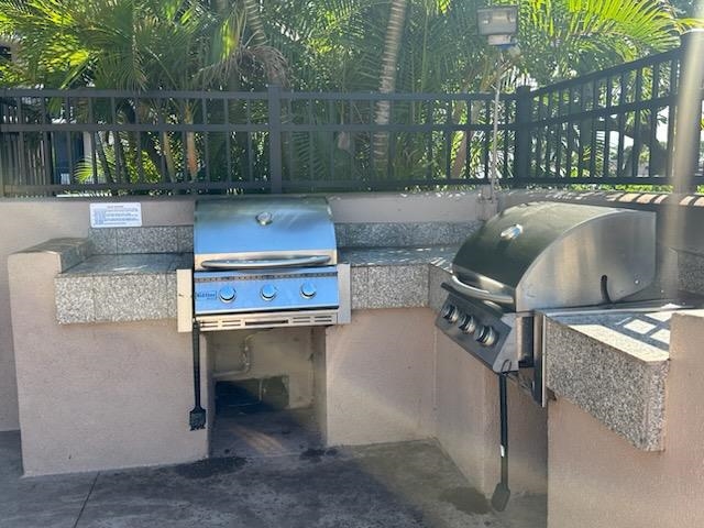 2219 South Kihei Road, Unit B402 Kihei, HI 96753 - Photo 5 of 5 a view of a patio with table and chairs with wooden floor