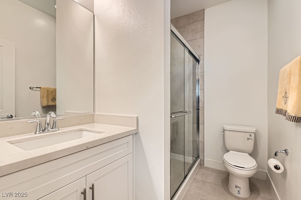 130 West Fairway Road Henderson, NV 89015 - Photo 24 of 40 Bathroom with a shower stall, light tile patterned floors, and vanity