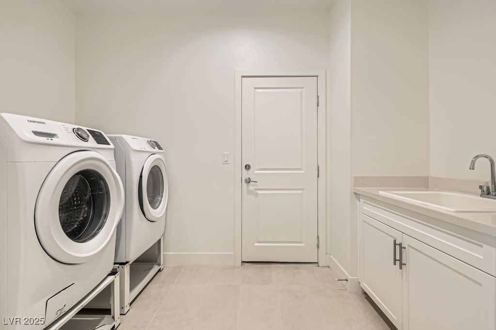 130 West Fairway Road Henderson, NV 89015 - Photo 29 of 40 Washroom featuring washer and dryer, cabinet space, and light tile patterned flooring