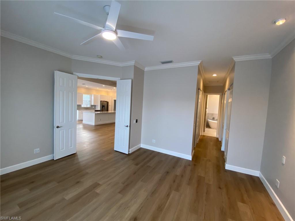 2740 Island Pond Lane Naples, FL 34119 - Photo 10 of 43 a view of a hallway with wooden floor