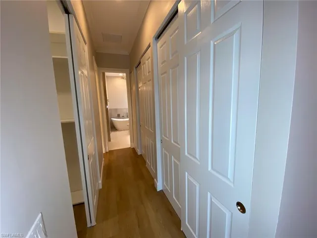 a view of a big room with wooden floor and a window