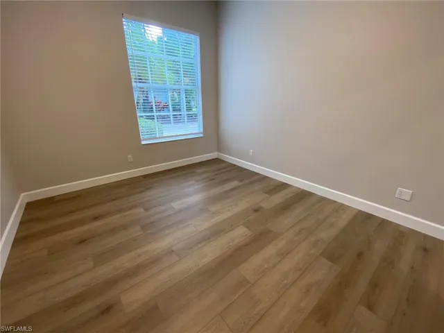 a spacious bathroom with a double vanity sink a toilet and a tub