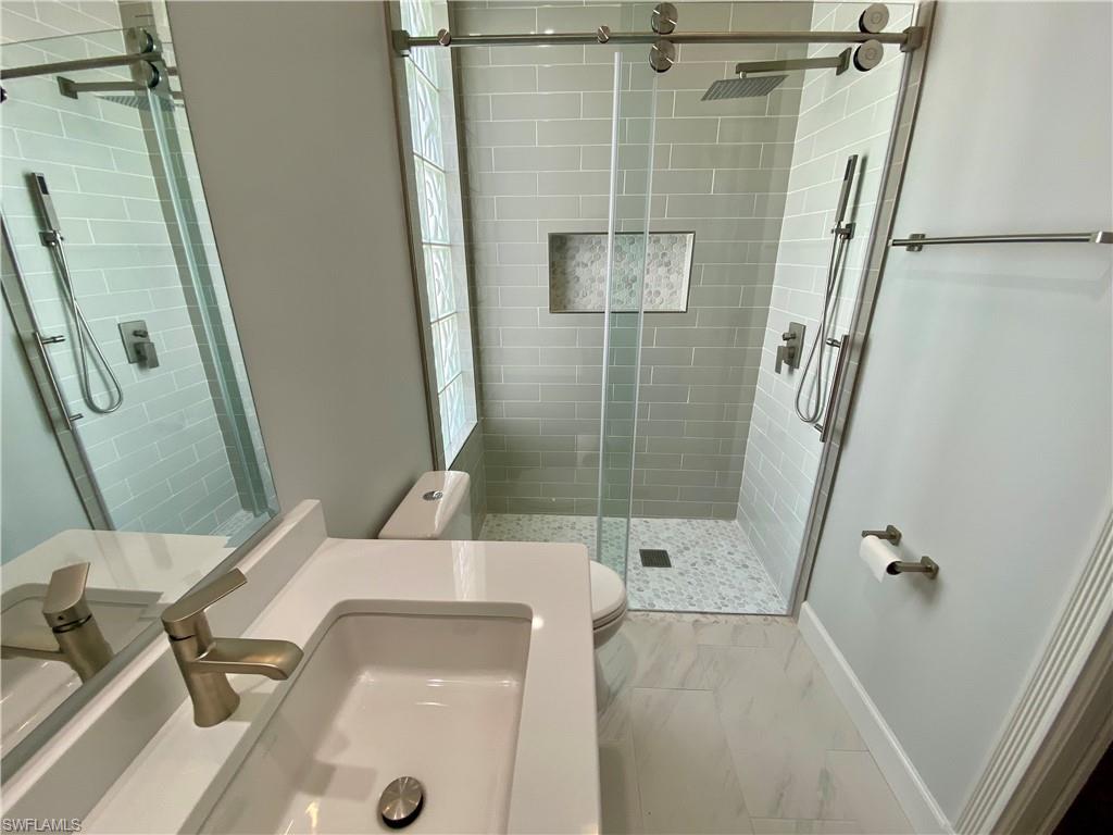 2740 Island Pond Lane Naples, FL 34119 - Photo 20 of 43 a bathroom with a shower and a sink