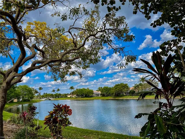 a view of a lake with houses in the back