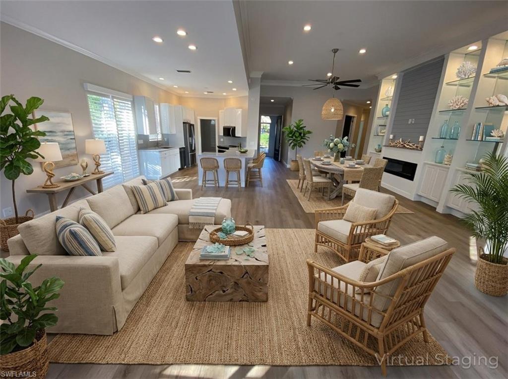 2740 Island Pond Lane Naples, FL 34119 - Photo 31 of 43 a living room with furniture kitchen view and a potted plant