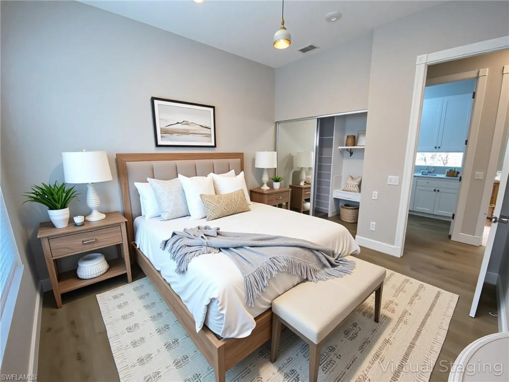 2740 Island Pond Lane Naples, FL 34119 - Photo 39 of 43 a bedroom with a bed and a table