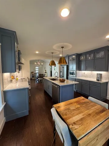 a kitchen with a sink and wooden cabinets