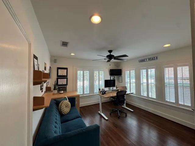 a workspace with furniture and a large window