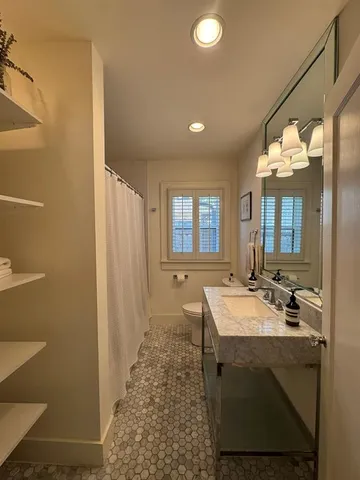 a bathroom with a sink a mirror and a shower