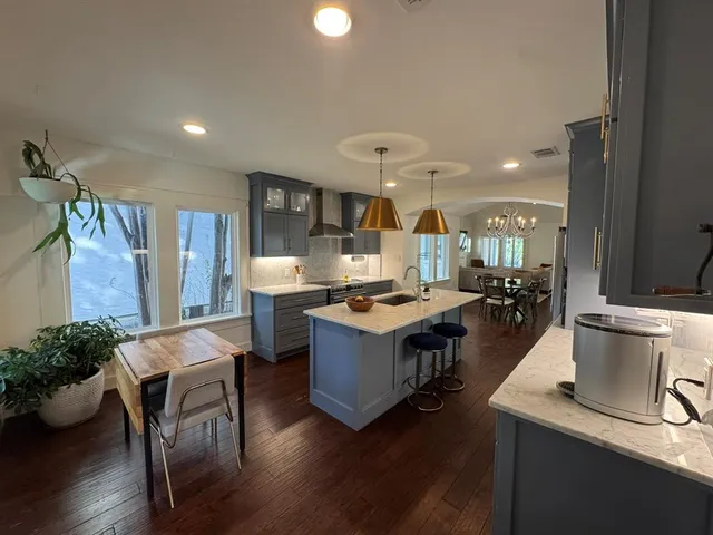 a large kitchen with a table and chairs