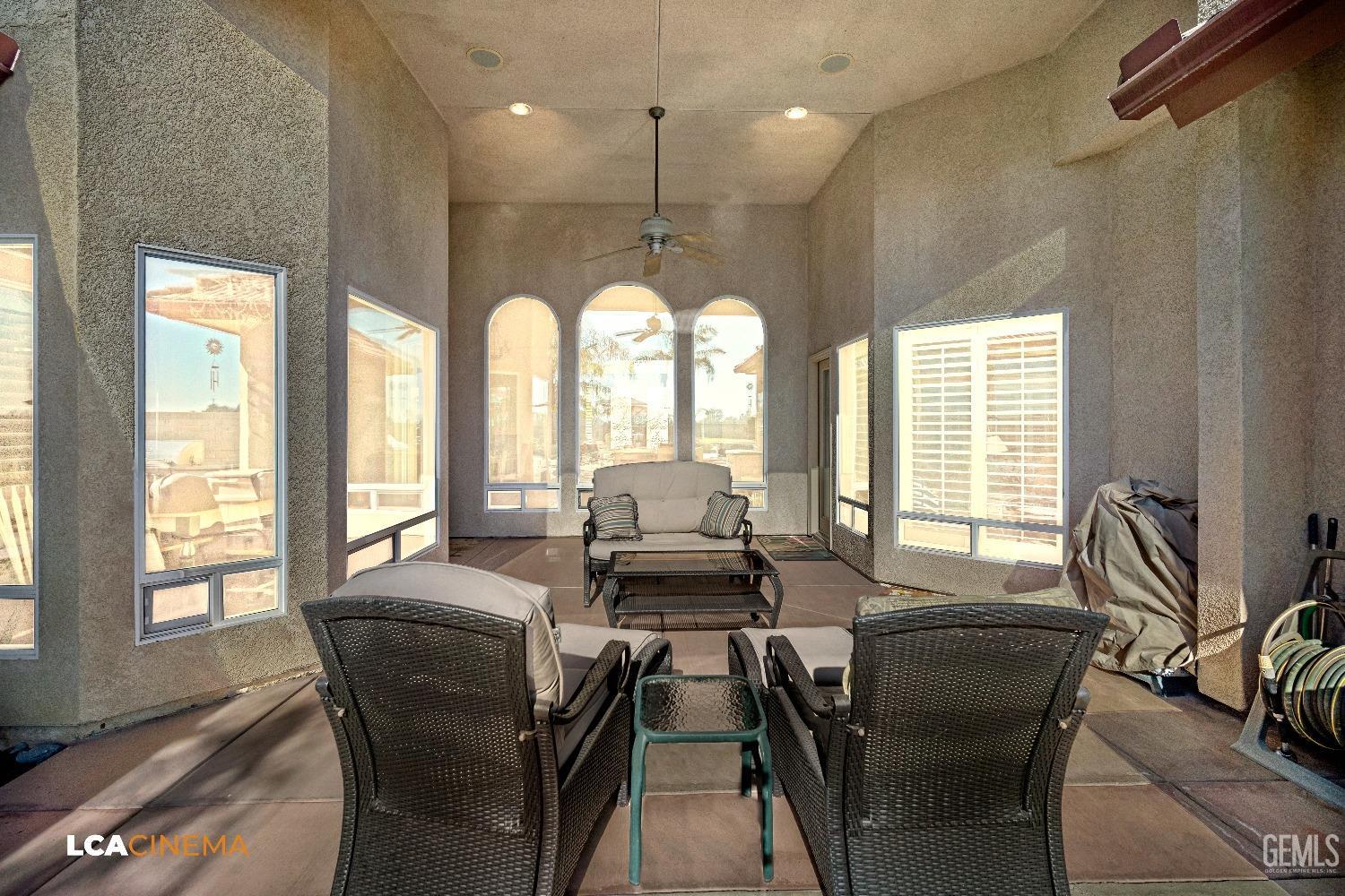 Undisclosed Address Bakersfield, CA 93314 - Photo 13 of 71 a dining room with furniture large windows and a chandelier
