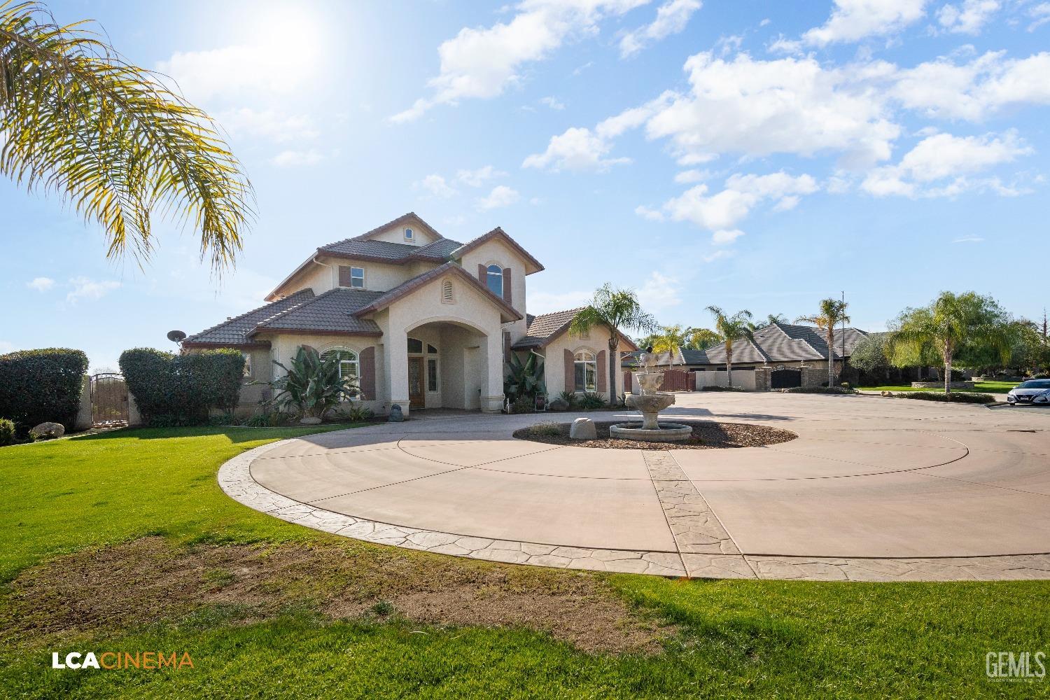 Undisclosed Address Bakersfield, CA 93314 - Photo 19 of 71 a view of a white house with a yard plants and palm trees