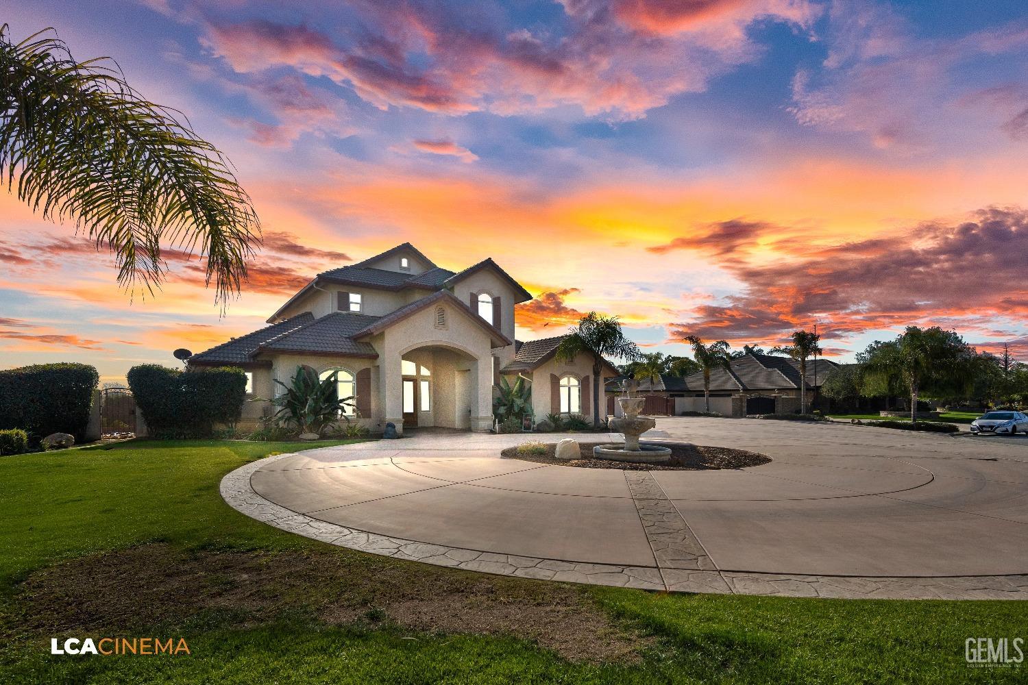 Undisclosed Address Bakersfield, CA 93314 - Photo 2 of 71 a view of a white house with a big yard and a fountain