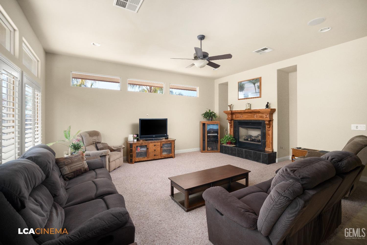 Undisclosed Address Bakersfield, CA 93314 - Photo 30 of 71 a living room with furniture a fireplace and a flat screen tv