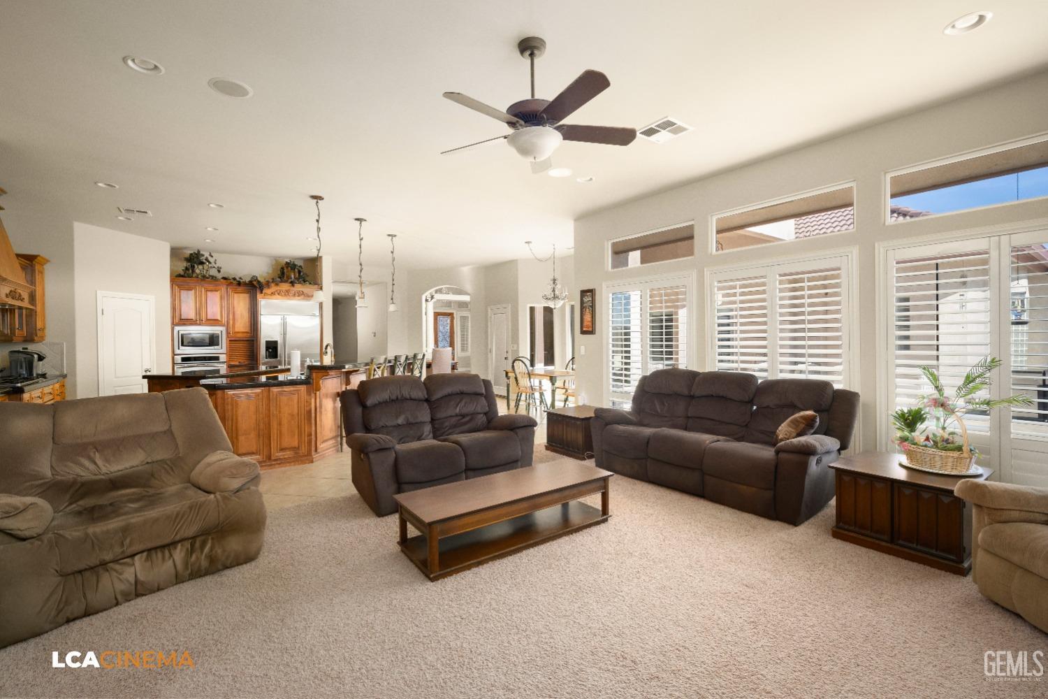 Undisclosed Address Bakersfield, CA 93314 - Photo 31 of 71 a living room with furniture ceiling fan and a large window