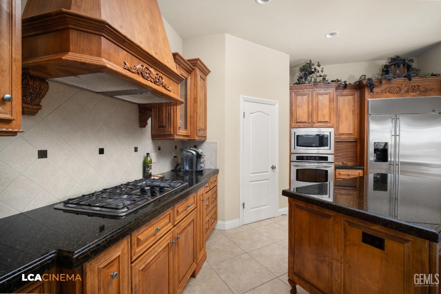 Undisclosed Address Bakersfield, CA 93314 - Photo 37 of 71 a kitchen with stainless steel appliances granite countertop a stove a refrigerator and a sink