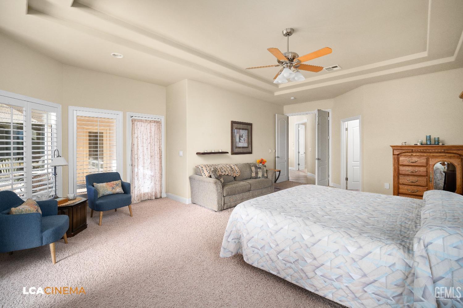 Undisclosed Address Bakersfield, CA 93314 - Photo 40 of 71 a spacious bedroom with a bed a couch and a chandelier