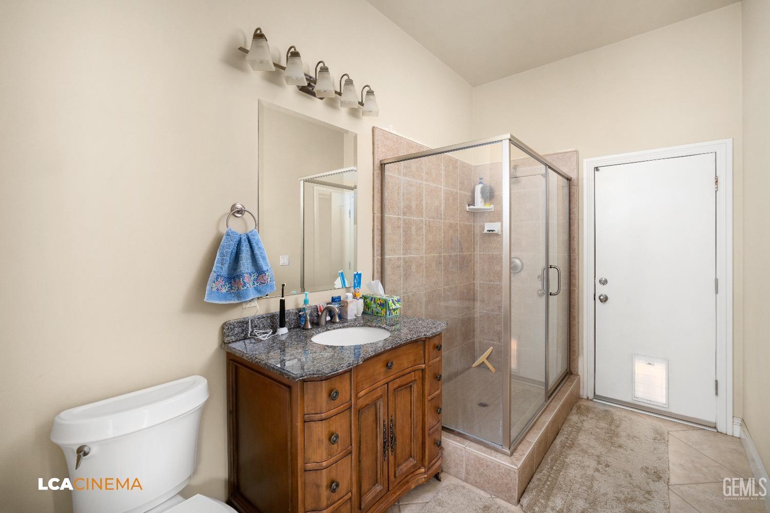 Undisclosed Address Bakersfield, CA 93314 - Photo 45 of 71 a bathroom with a granite countertop sink toilet and shower