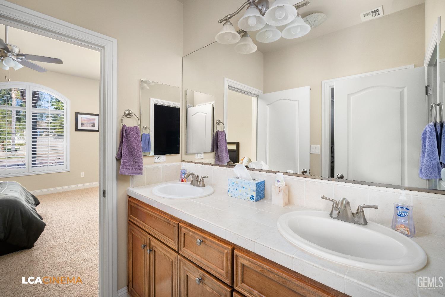 Undisclosed Address Bakersfield, CA 93314 - Photo 49 of 71 a bathroom with a sink double vanity and a mirror