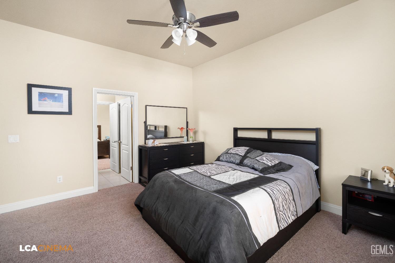 Undisclosed Address Bakersfield, CA 93314 - Photo 51 of 71 a bedroom with a bed and a chandelier