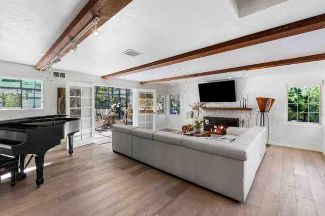 a living room with furniture fireplace and a flat screen tv