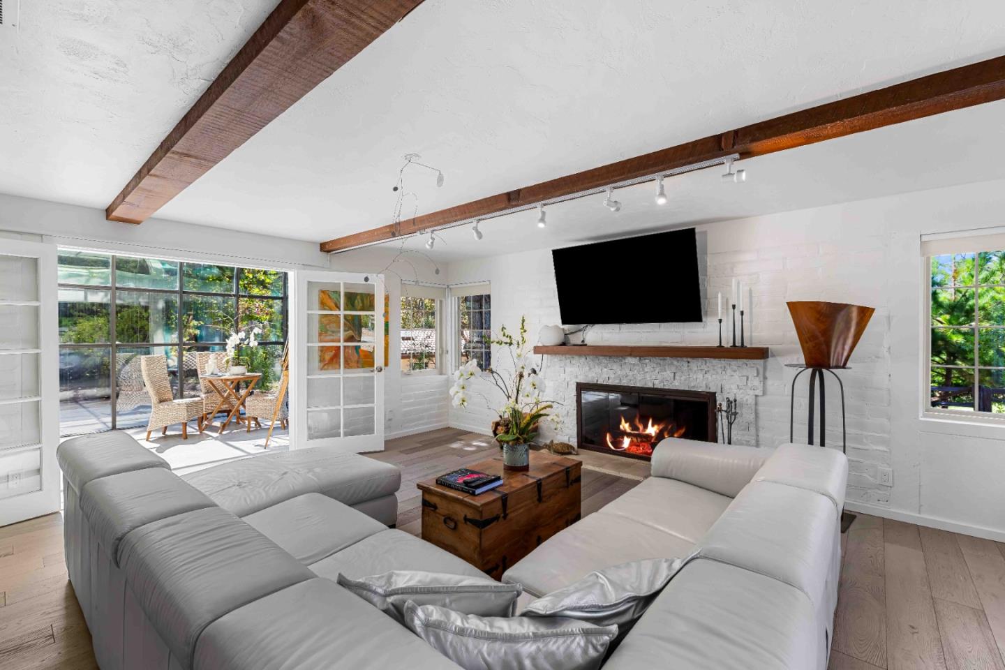 1268 Viscaino Road Pebble Beach, CA 93953 - Photo 12 of 47 a living room with furniture fireplace and a flat screen tv