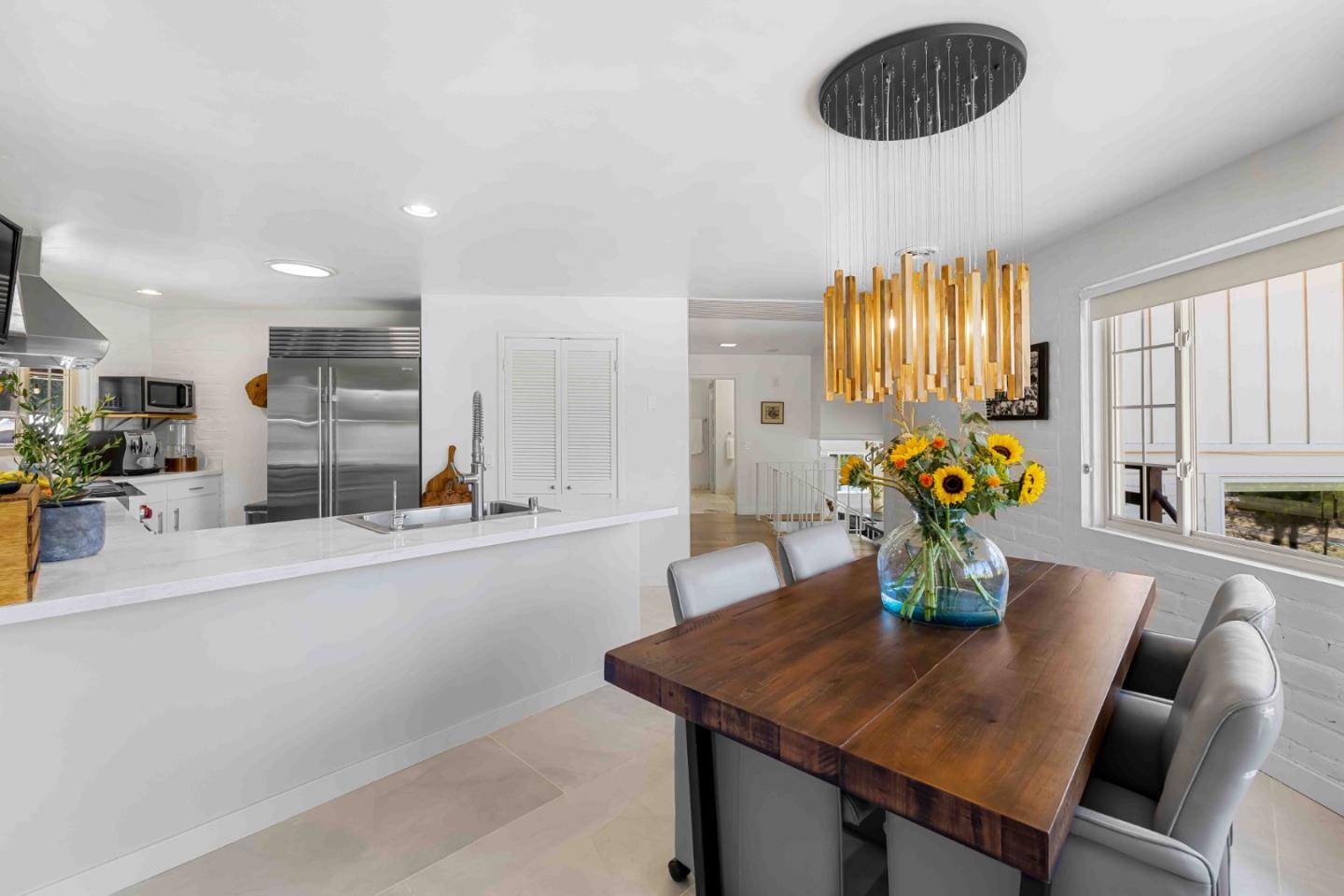 1268 Viscaino Road Pebble Beach, CA 93953 - Photo 19 of 47 a dining room with furniture and a chandelier