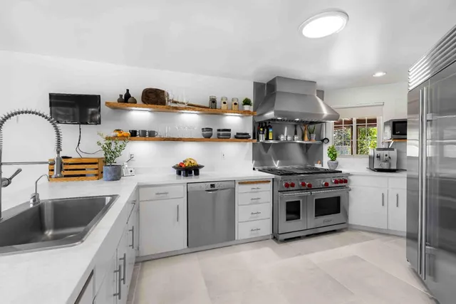 a kitchen with stainless steel appliances granite countertop a stove and a sink