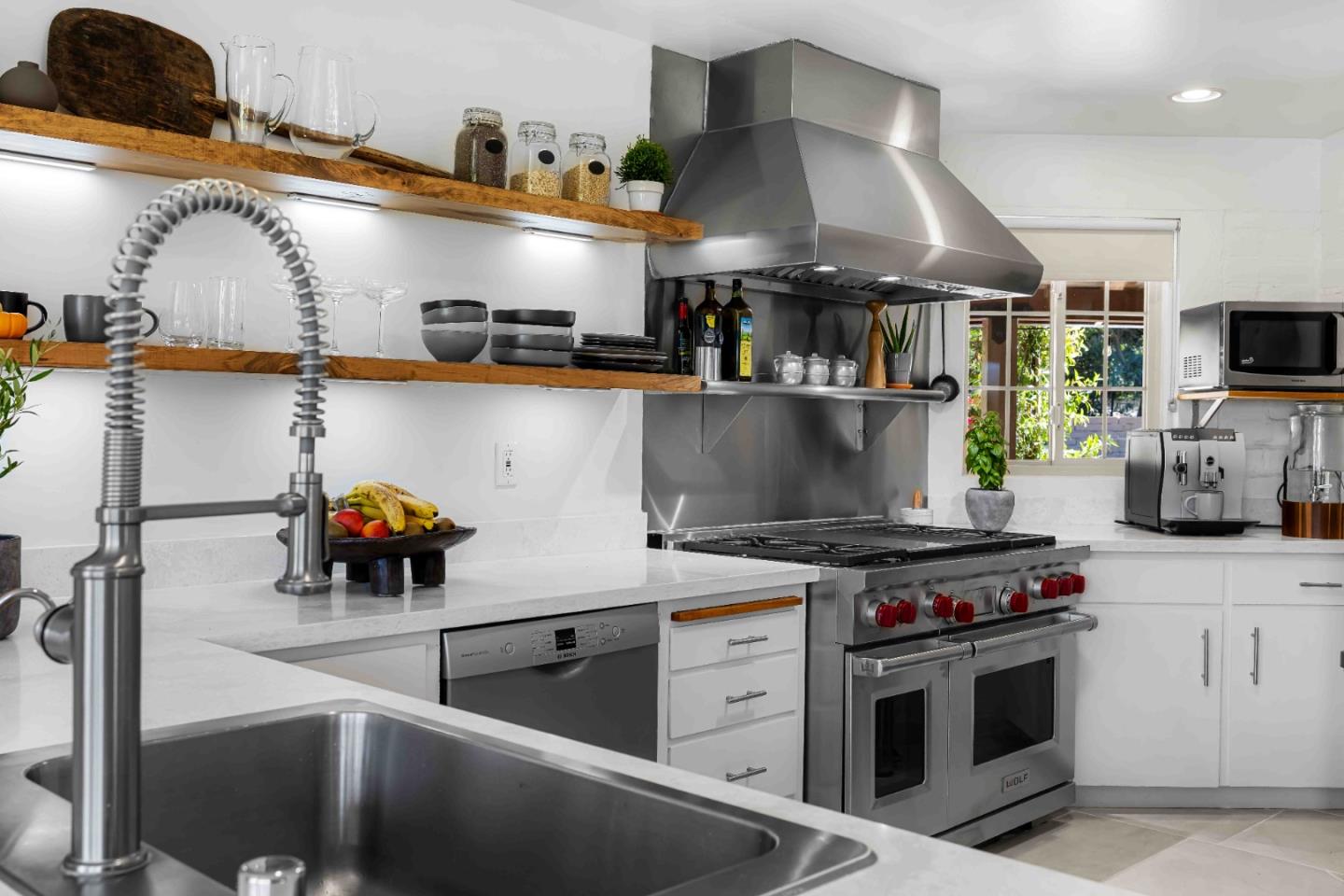 1268 Viscaino Road Pebble Beach, CA 93953 - Photo 21 of 47 a kitchen with stainless steel appliances granite countertop a stove and a sink