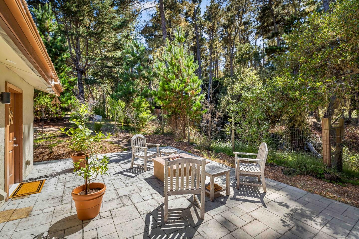 1268 Viscaino Road Pebble Beach, CA 93953 - Photo 28 of 47 a view of a patio with couple of chairs and potted plants