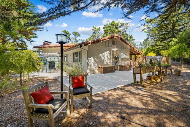 a backyard of a house with table and chairs