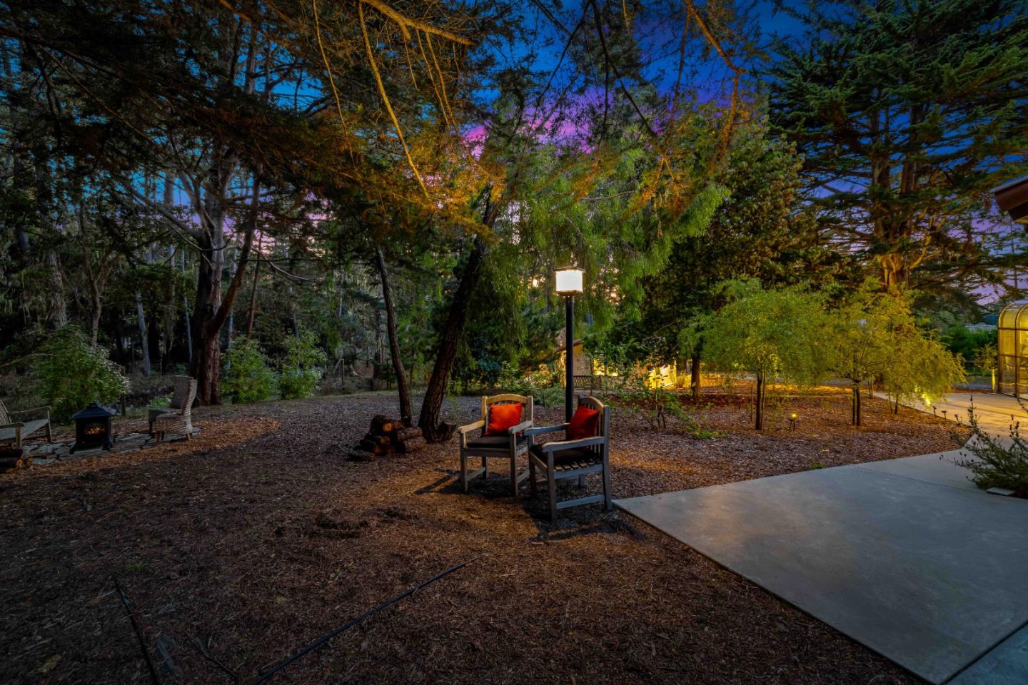 1268 Viscaino Road Pebble Beach, CA 93953 - Photo 31 of 47 a backyard of a house with table and chairs