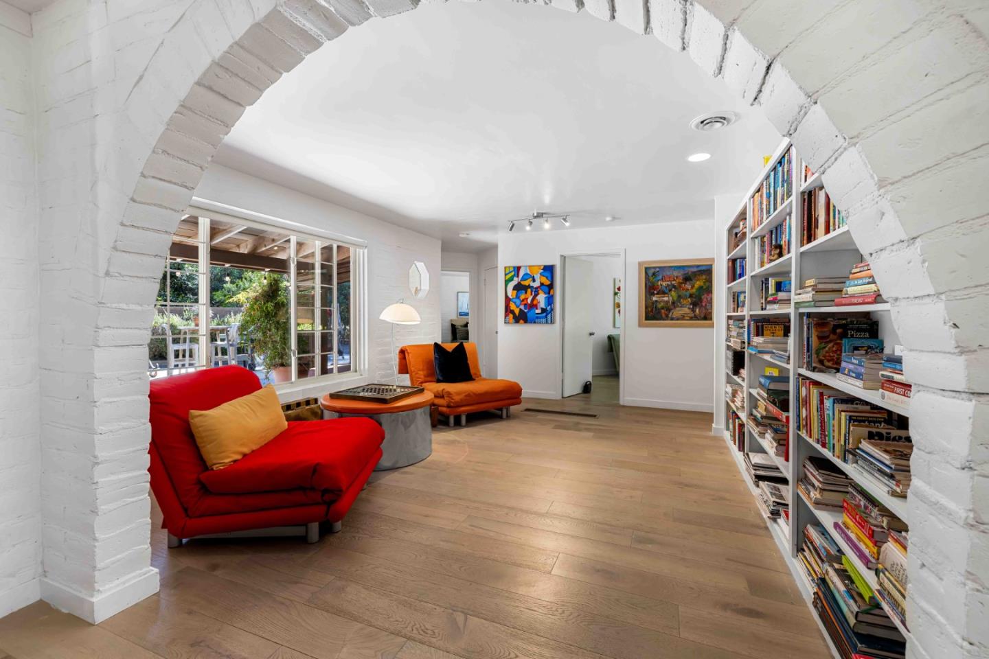 1268 Viscaino Road Pebble Beach, CA 93953 - Photo 9 of 47 a living room with furniture and a book shelf