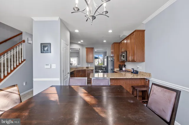 a view of a kitchen and dining room with wooden floor