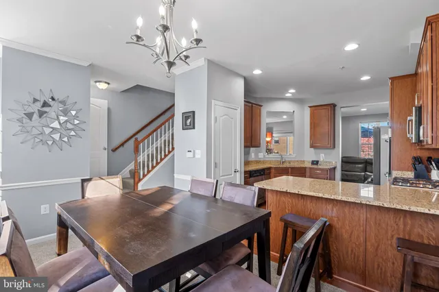 a view of a dining room with furniture a chandelier and wooden floor