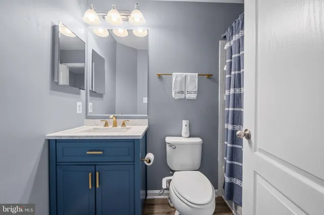 a bathroom with a toilet a sink and mirror