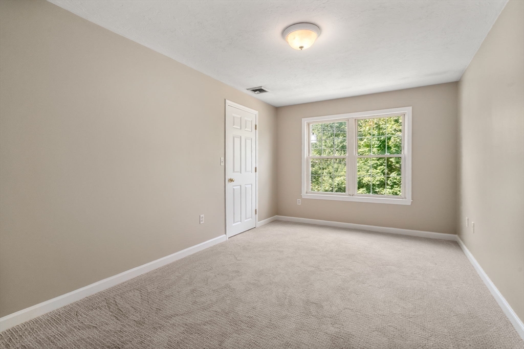 33 Fuller Avenue, Unit 33 Attleboro, MA 02703 - Photo 11 of 16 an empty room with windows and yard