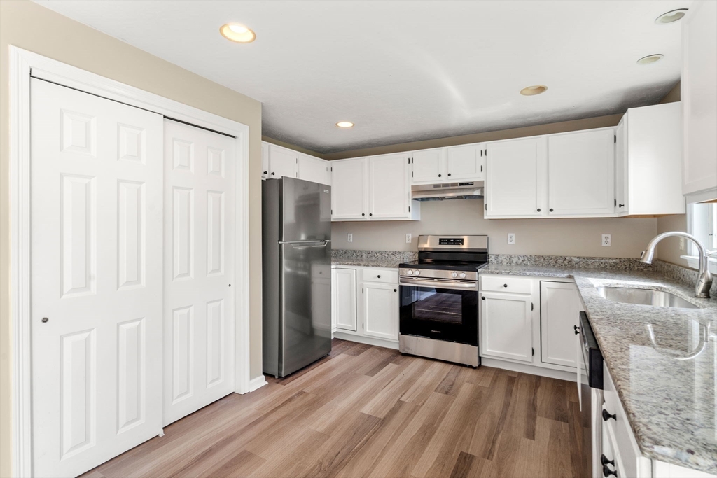 33 Fuller Avenue, Unit 33 Attleboro, MA 02703 - Photo 3 of 16 a kitchen with granite countertop white cabinets and stainless steel appliances