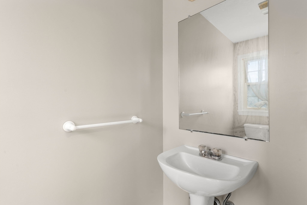 33 Fuller Avenue, Unit 33 Attleboro, MA 02703 - Photo 5 of 16 a bathroom with a sink a mirror and a toilet