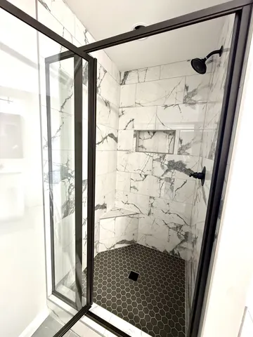 a view of a room with a ceiling fan