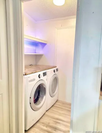 a view of storage and utility room with wooden floor