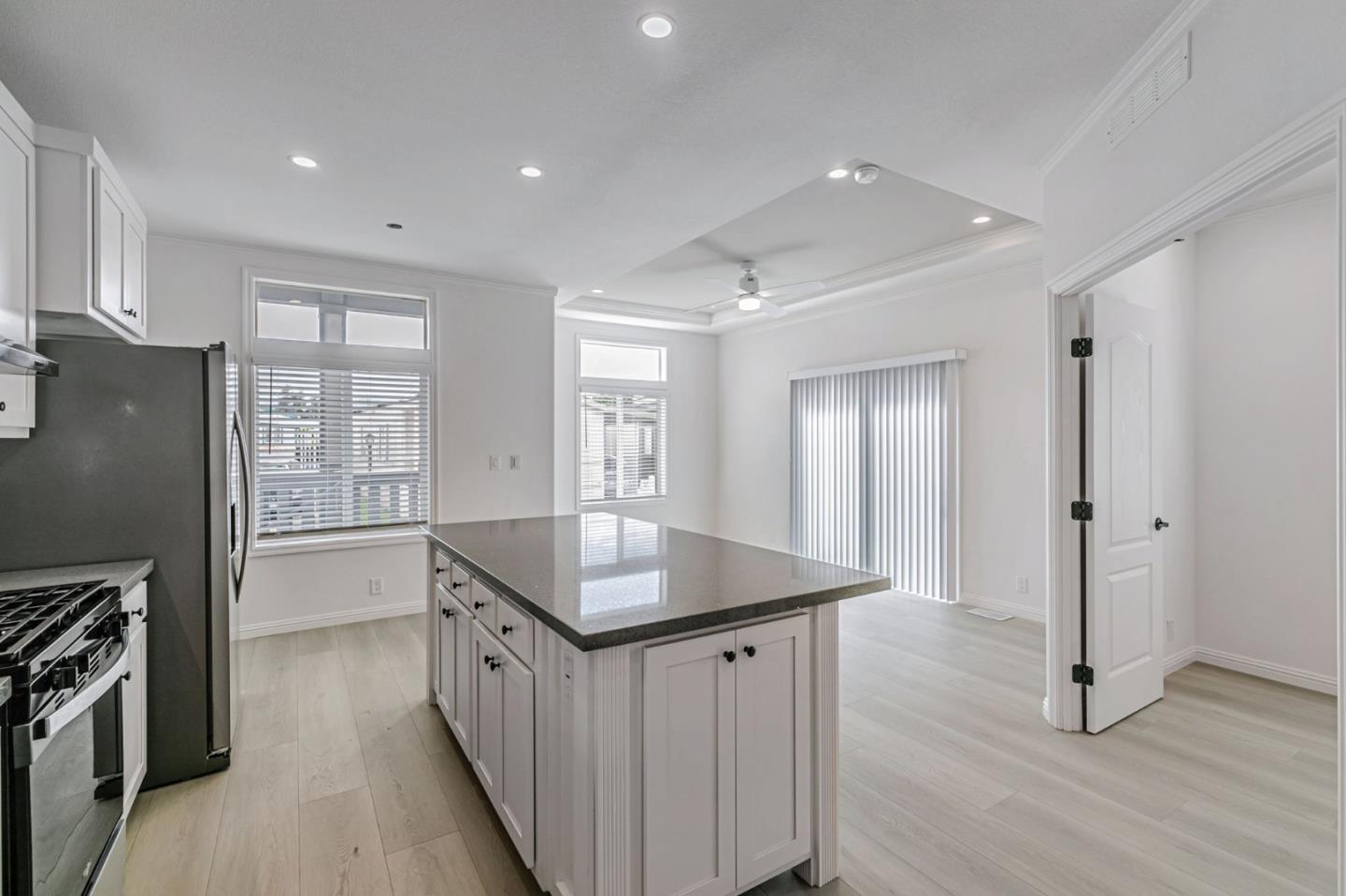 555 Umbarger Road, Unit 131 San Jose, CA 95111 - Photo 13 of 29 a kitchen with stainless steel appliances granite countertop a refrigerator a stove and a sink