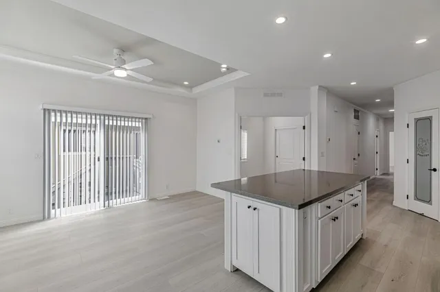 a kitchen with stainless steel appliances granite countertop a refrigerator and a stove top oven