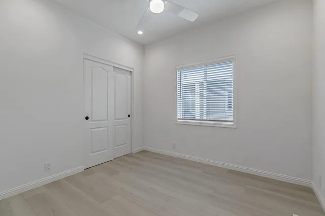 a view of a room with a hardwood and a window