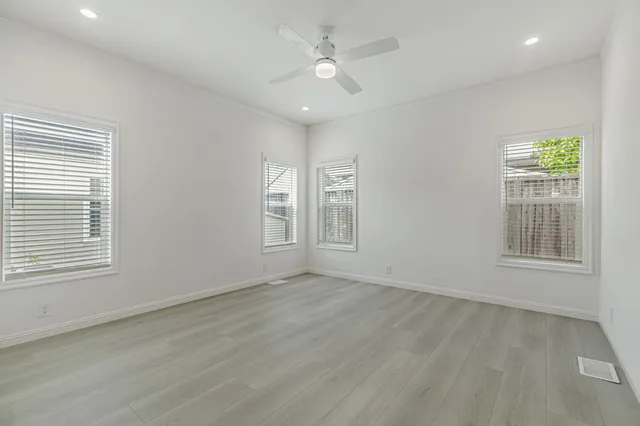 wooden floor in an empty room with a window