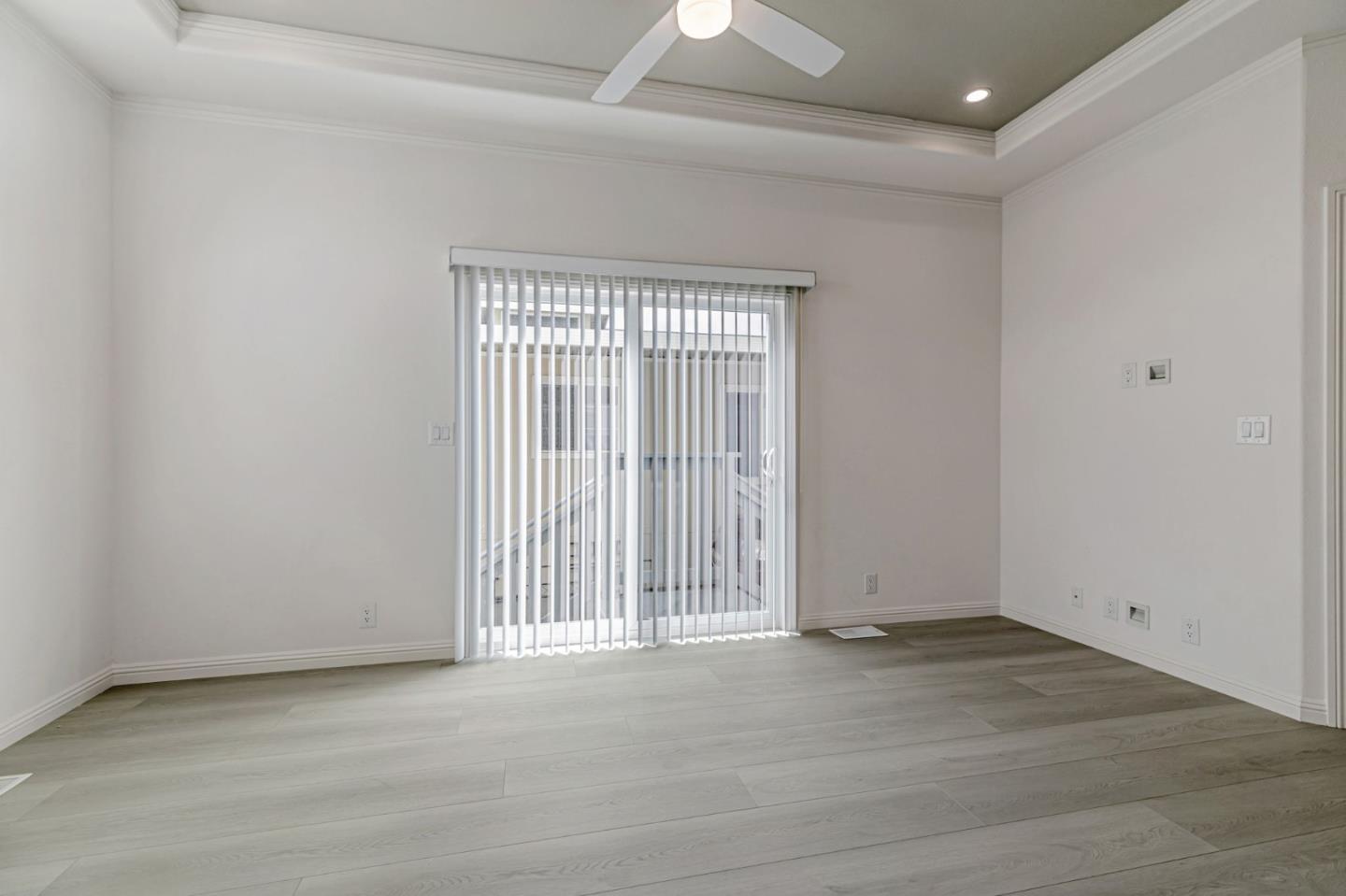 555 Umbarger Road, Unit 131 San Jose, CA 95111 - Photo 7 of 29 an empty room with wooden floor and windows