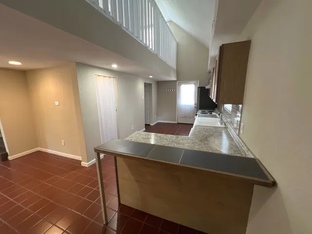a view of a living room and kitchen