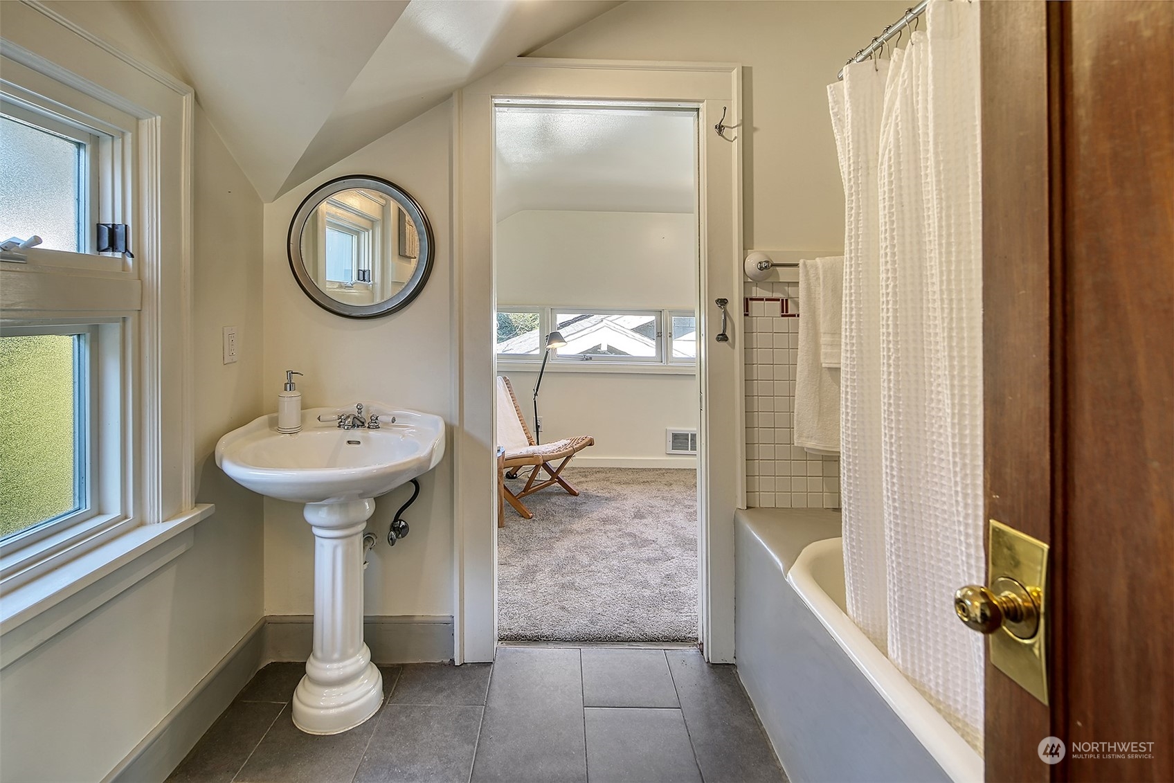 4715 Stone Way North Seattle, WA 98103 - Photo 20 of 30 a bathroom with a sink a toilet and shower