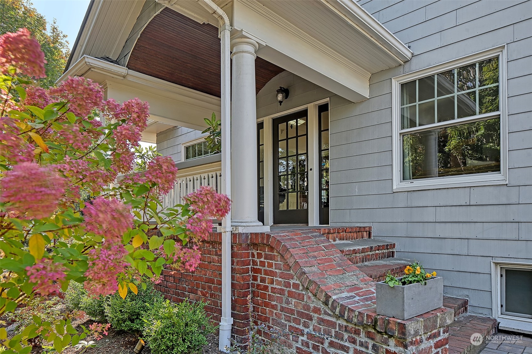 4715 Stone Way North Seattle, WA 98103 - Photo 2 of 30 a front view of a house with an outdoor space and seating