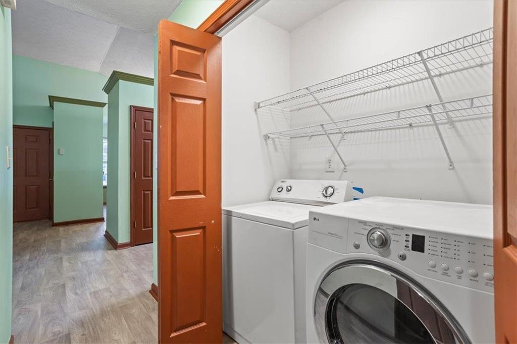 150 Crystal Brook Griffin, GA 30223 - Photo 11 of 28 a view of washer and dryer with kitchen in the background